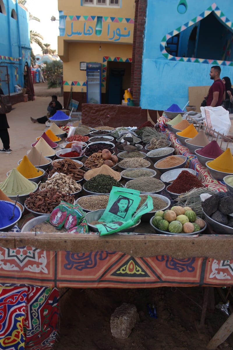 A table full of spices for sale in the market of a Nubian Village
