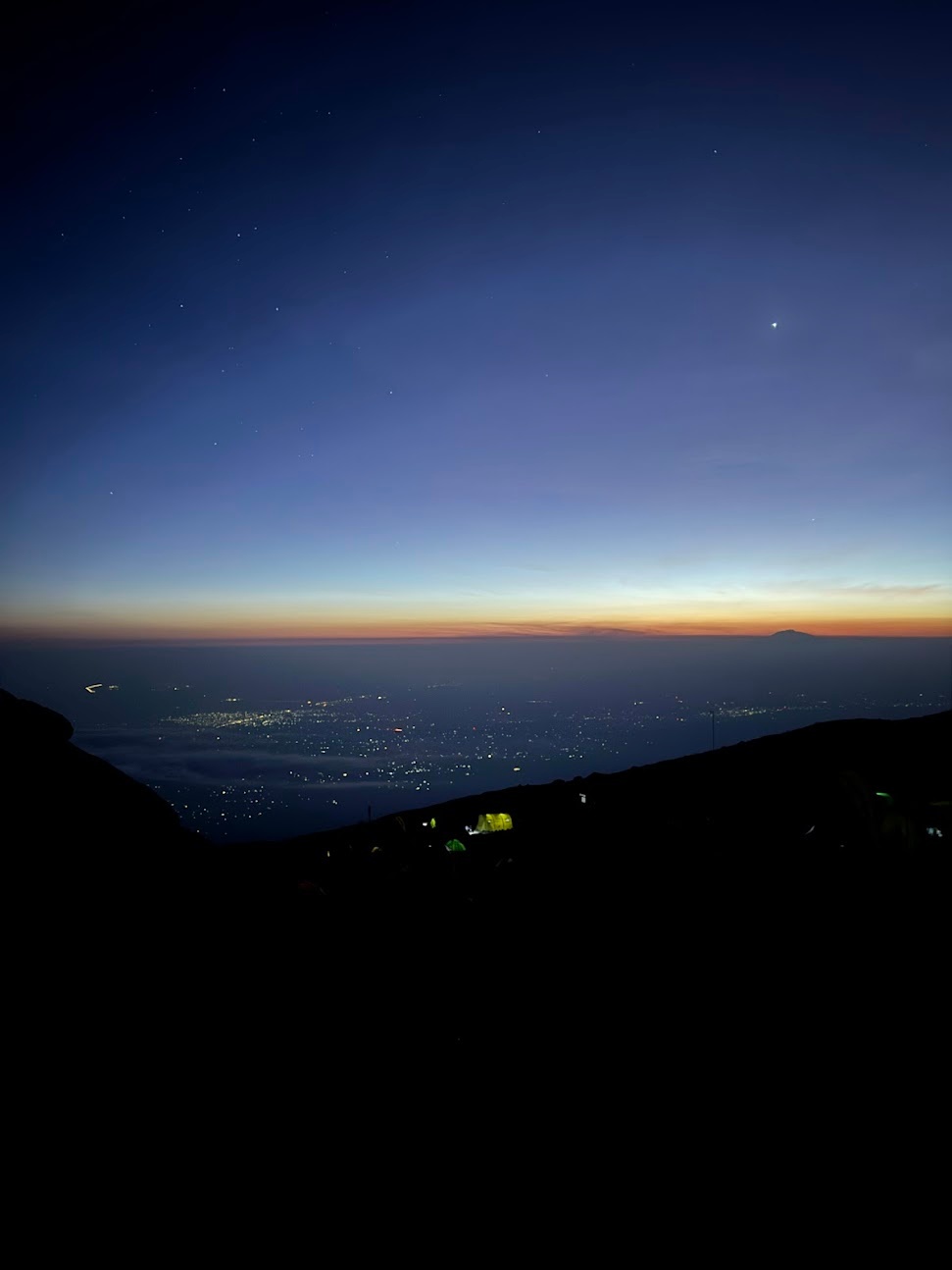 Sunset, with the lights of Moshi visible lower in the horizon