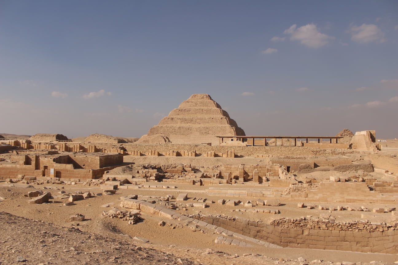 Overview of the Saqqara Pyramid complex, with the Djoser Pyramid on the background and ruins from tombs in front