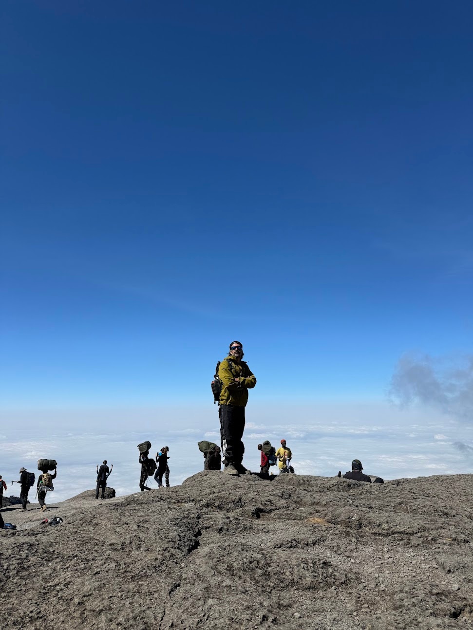 Cioga standing on a rock, only clouds in the background