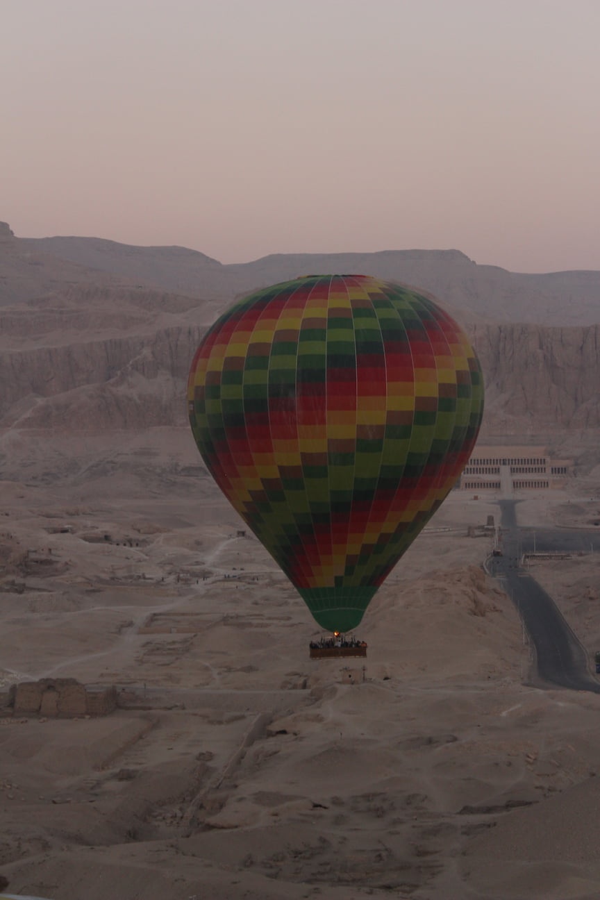 Hot air balloon flying over the Valley of the Kings, in Luxor, Egypt
