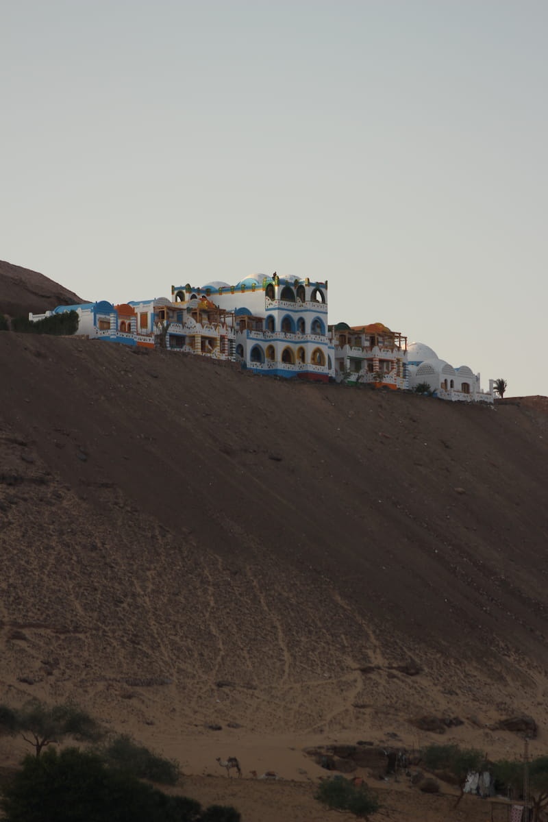 Colorful houses in a Nubian Village sitting on the edge of a dune
