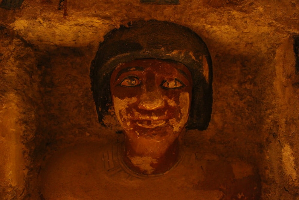 Detail of the face of a statue of a person, inside a tomb in Saqqara