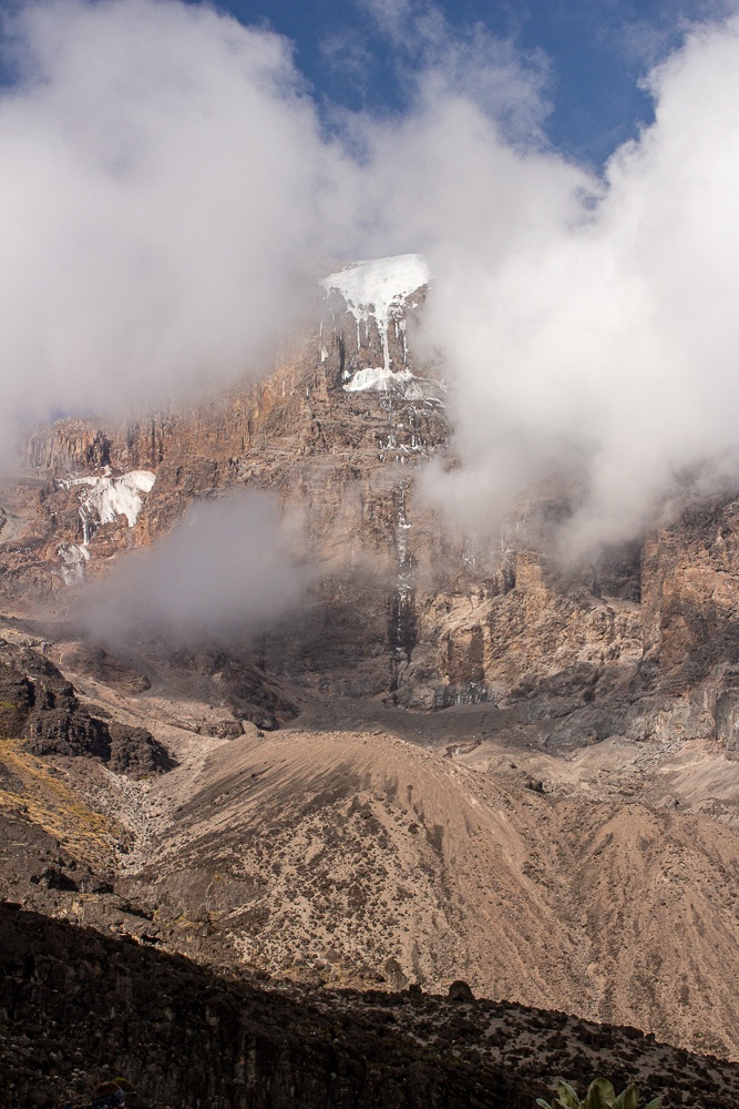 Barranco wall partially hidden by clouds with snow on the top