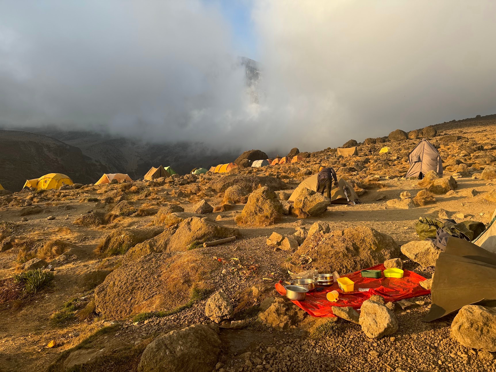 Sunset at Karanga Camp, with kitchen supplies drying in a towel outside the tent