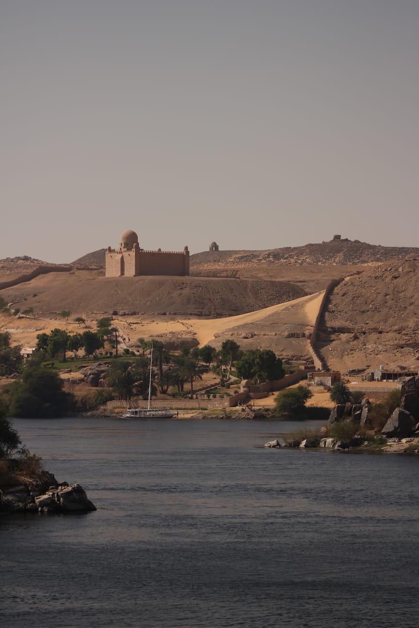 Nile river, a monument standing on the opposite river bank