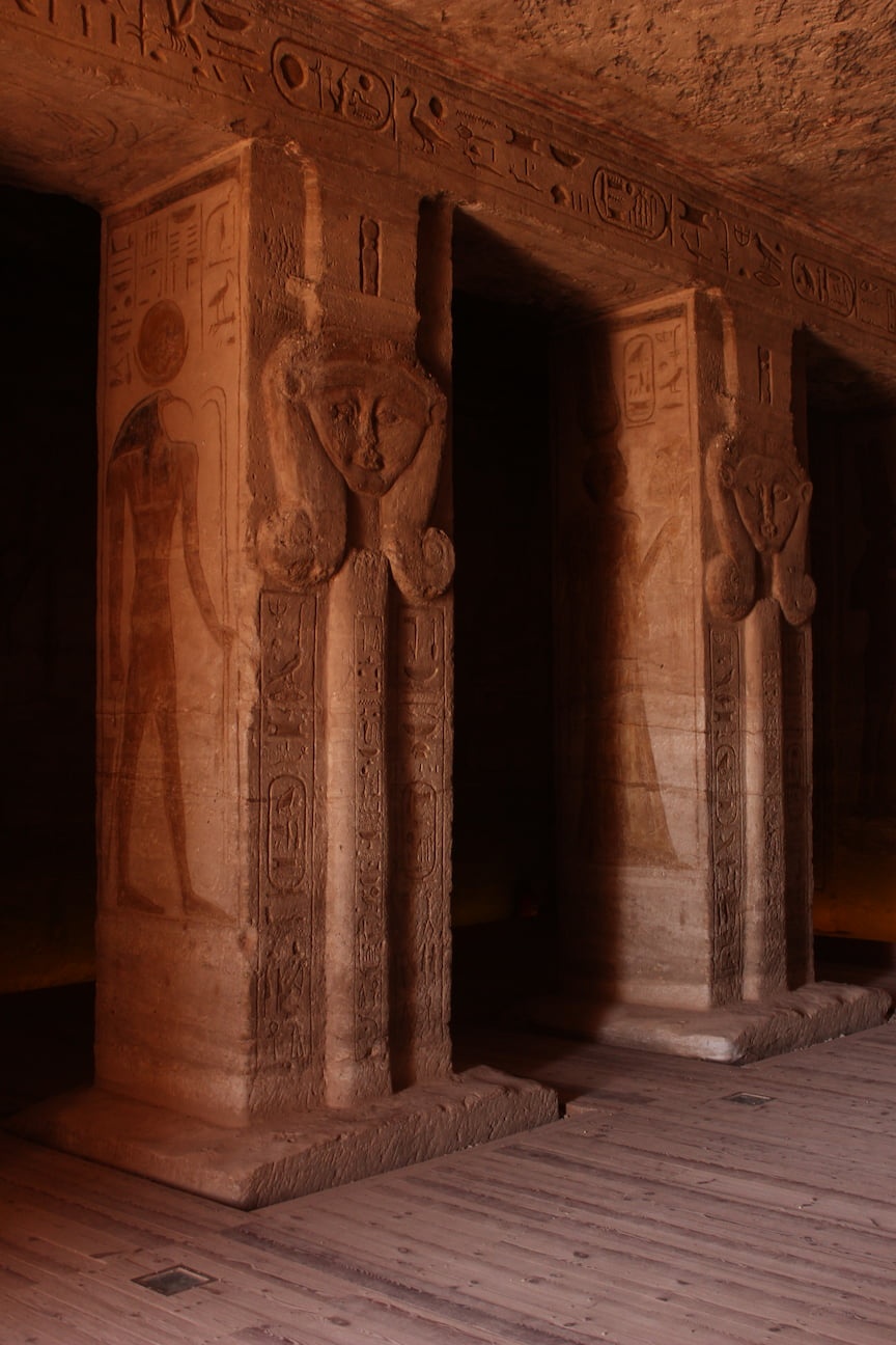 Details of the interior of the temple, columns adorned with hieroglyphs and faces carved on the stone