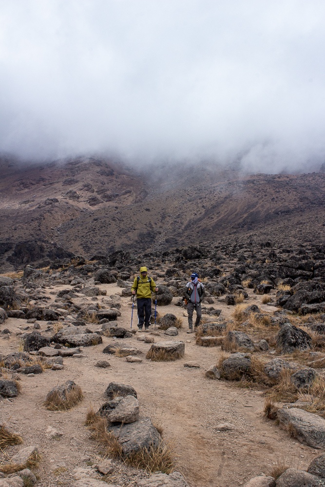 Cioga and Hussein walking through the rocky path