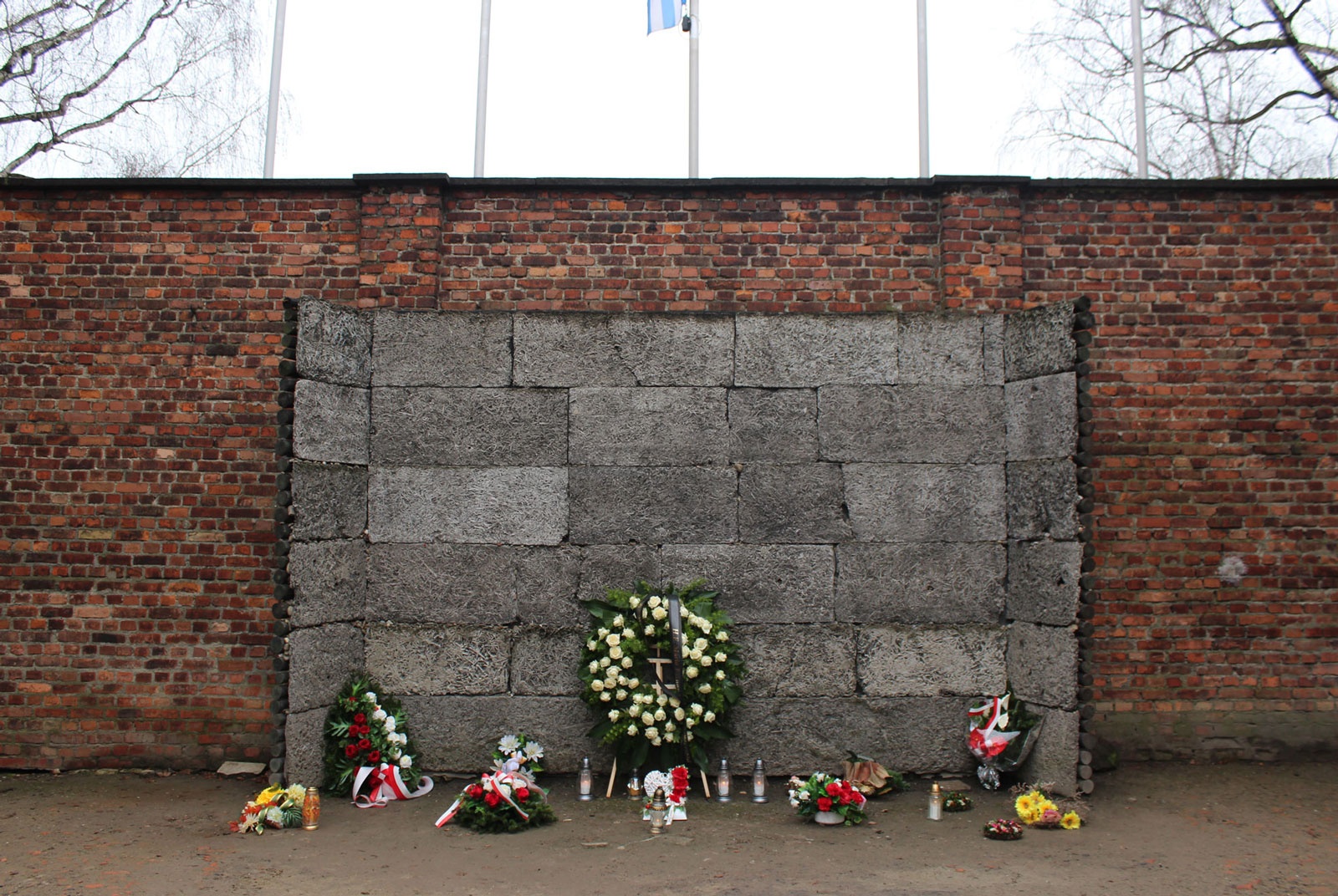 Execution wall, with floral arrangements