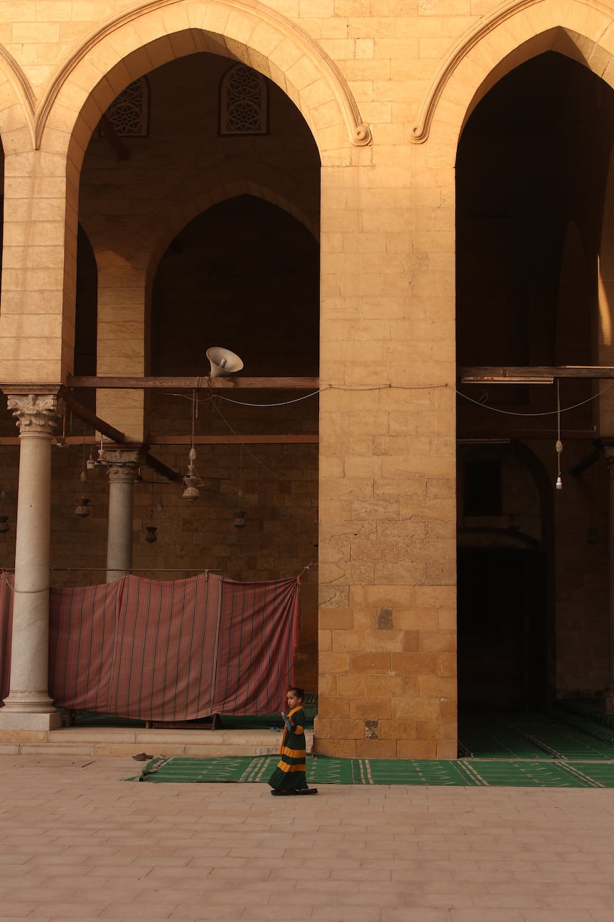 A little girl playing in the Mosque.