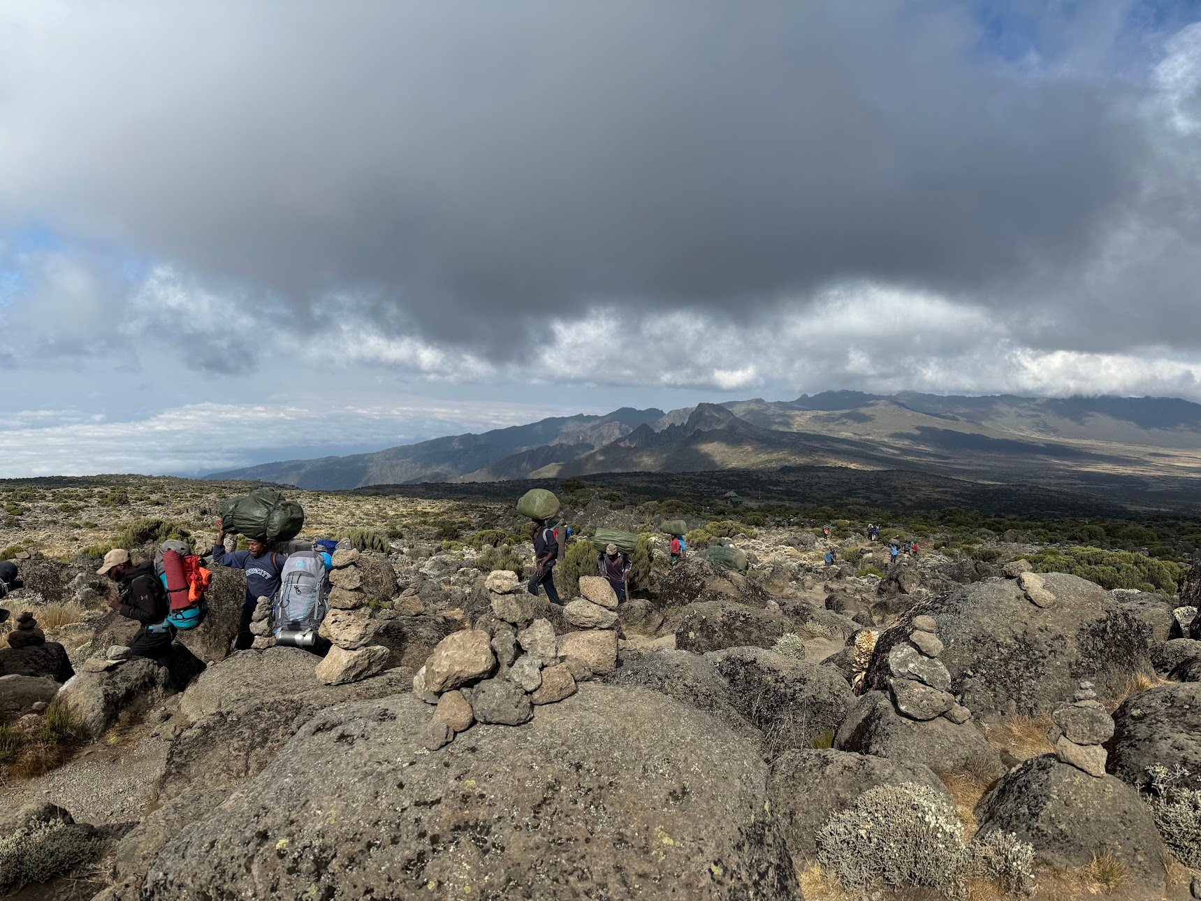 Porters make their way through the rocky path